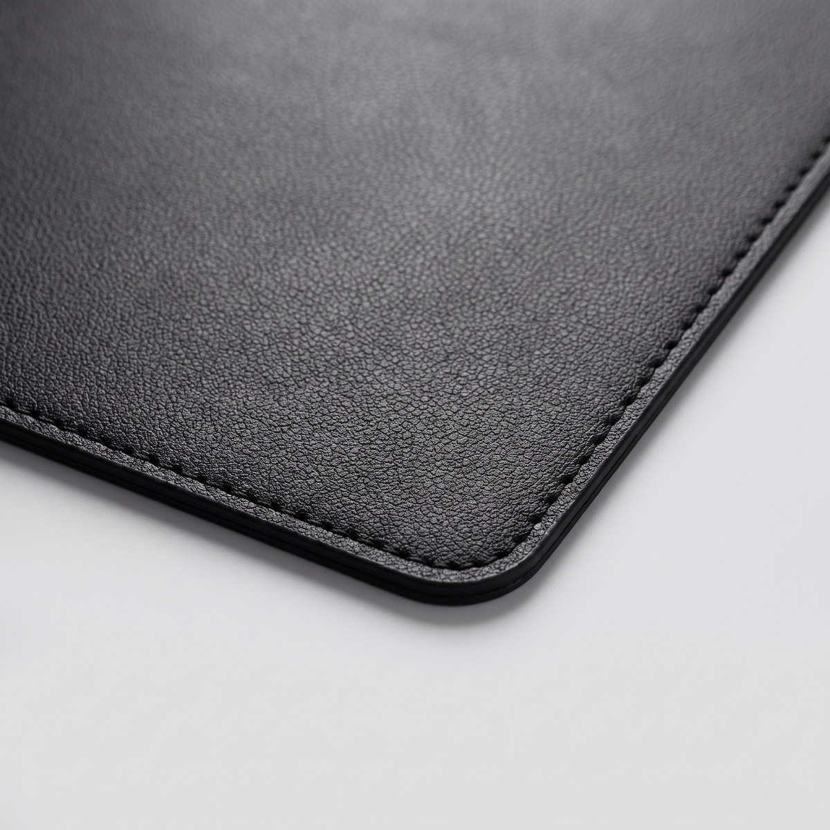 Close-up of the stitched edge of the Deskstead Desk Pad