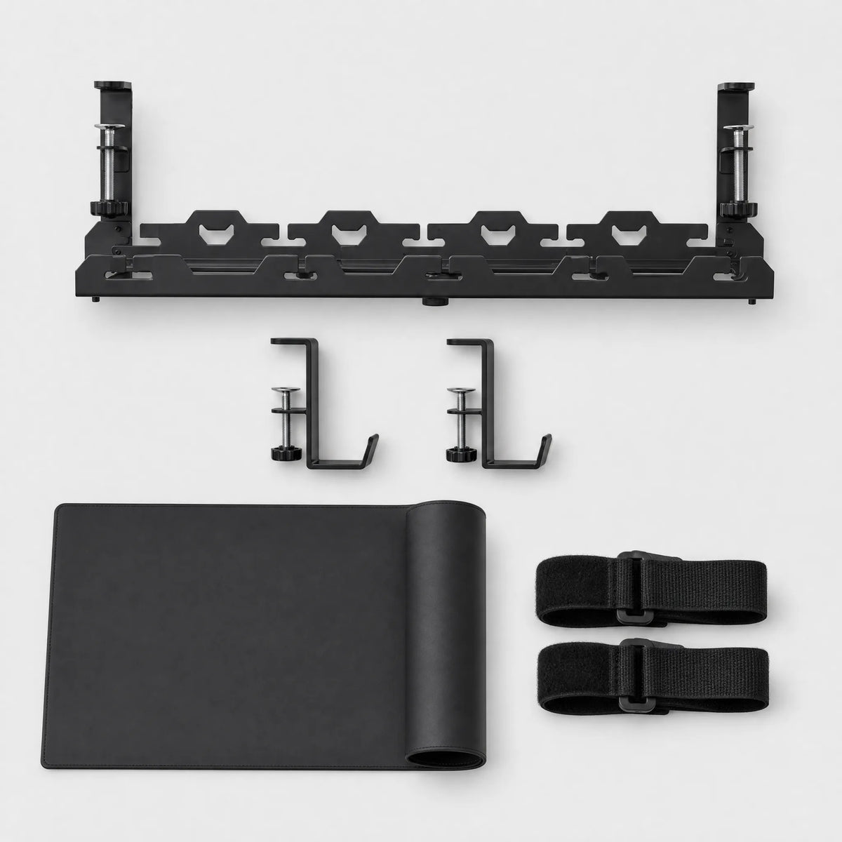The Deskstead Edge System kit: cable tray, two edge hooks, desk pad and reusable cable ties