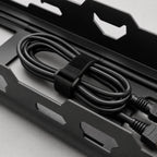 A cable bundle secured with a hook-and-loop strap inside the tray