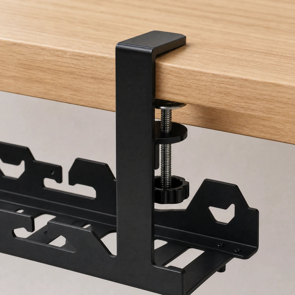 Close-up of the bracket arm hooked over the desk edge with the thumbscrew tightened